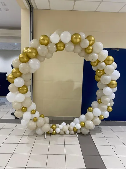 Celebration arch with gold and white balloon styling