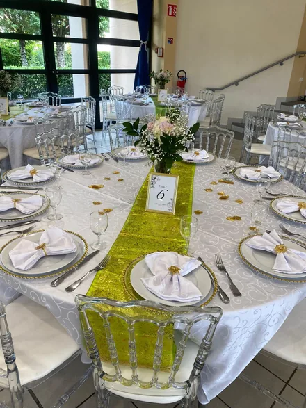 Wedding reception dining setup with a long table and centerpieces