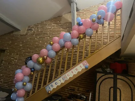 Gender reveal celebration with balloon detail on a staircase